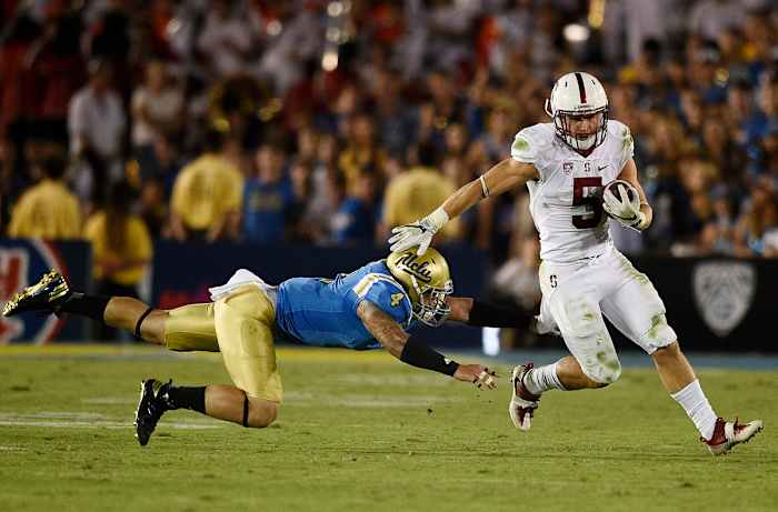 Sep 24, 2016; Pasadena, CA, USA; Stanford Cardinal running back Christian McCaffrey (5) runs the ball past UCLA Bruins linebacker Cameron Judge (4) during the second half at Rose Bowl. The Stanford Cardinal won 22-13. Mandatory Credit: Kelvin Kuo-USA TODAY Sports